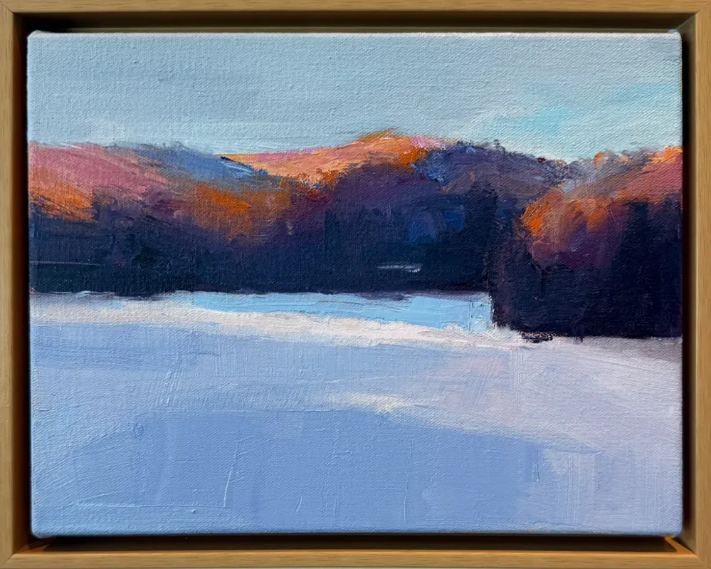 Oil on canvas landscape painting of a frozen lake with deep purple and orange-tinted hills reflected in cool blue and lavender tones, by Owen Sound artist Joanna Aplin.